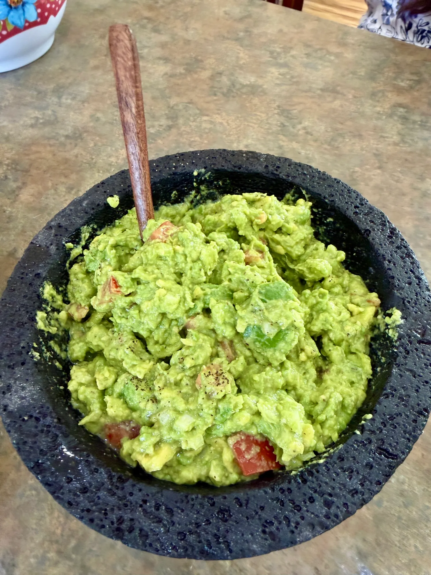 Fresh guacamole in a stone molcajete.