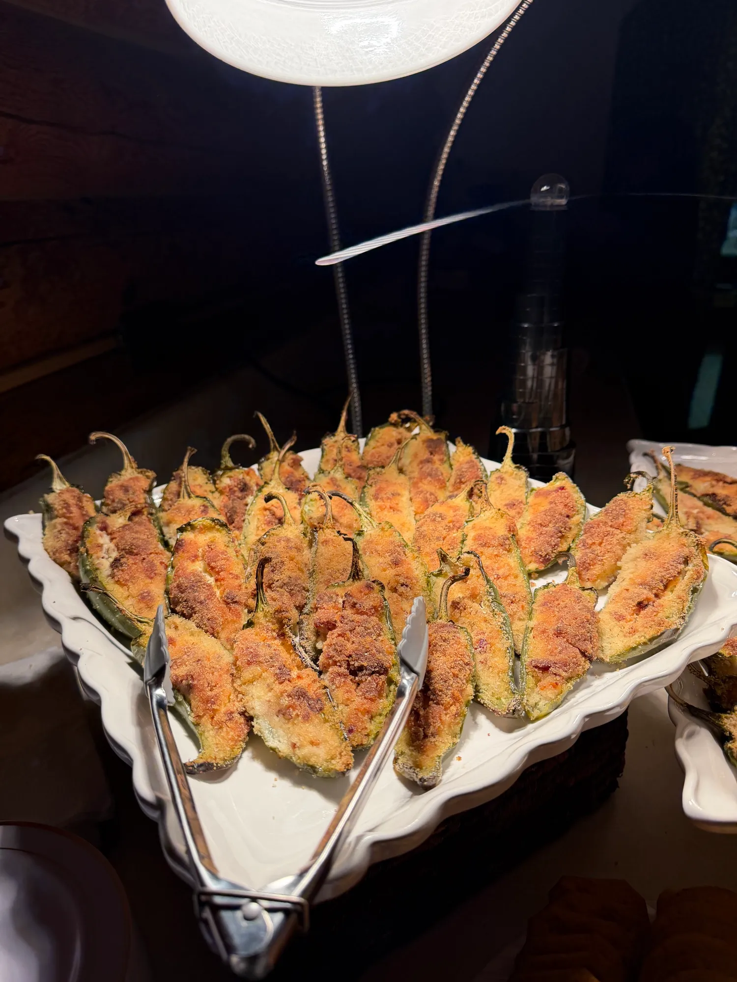 A tray of jalapeño poppers, filled and baked golden.