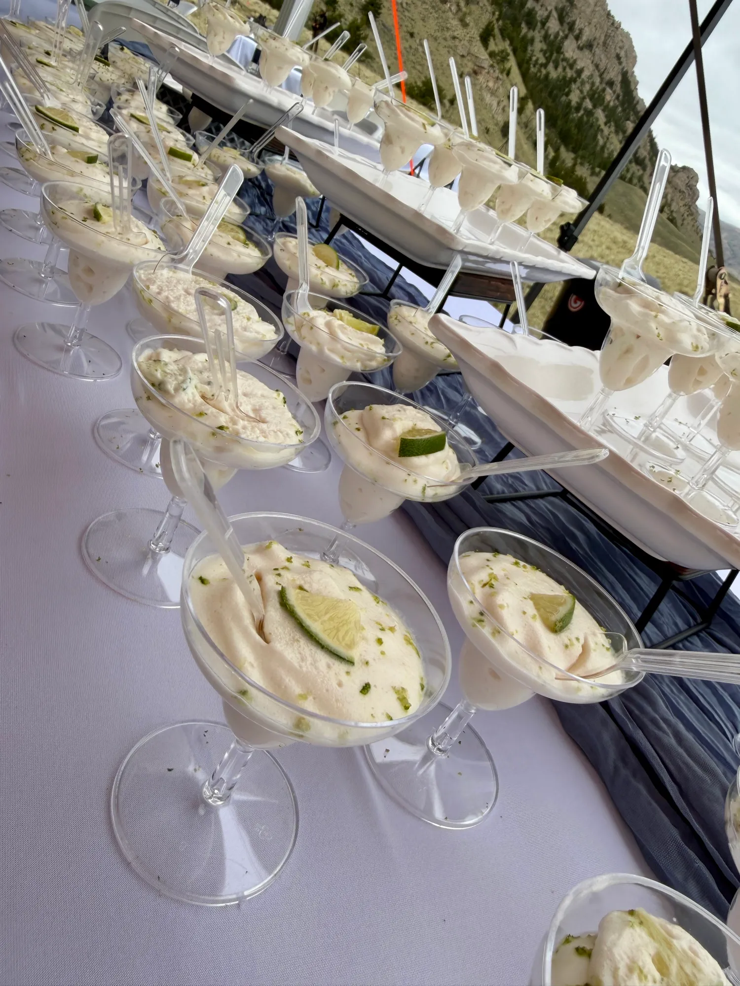 Individual dessert glasses garnished with lime.