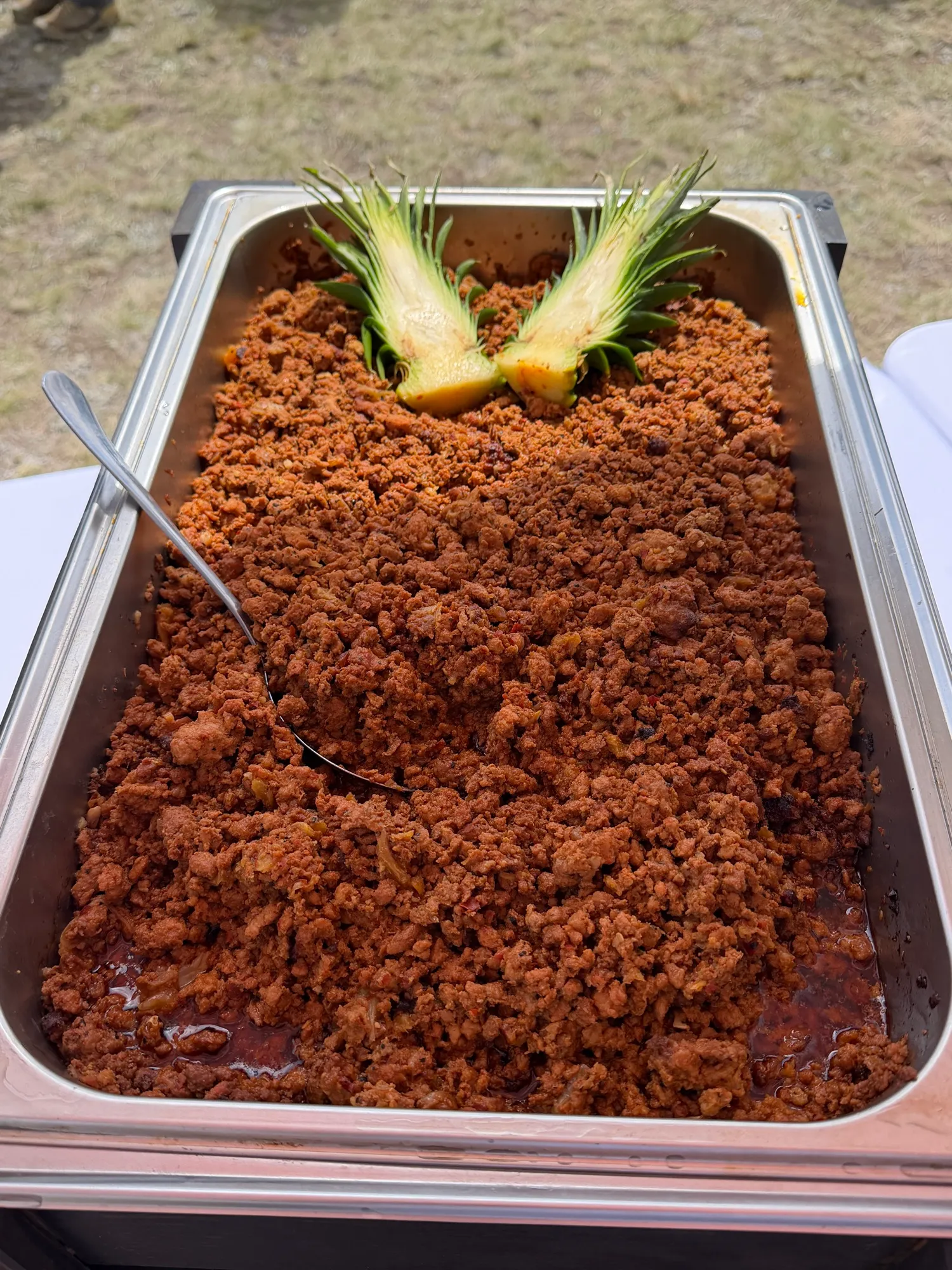 A full chafing tray of seasoned taco meat.