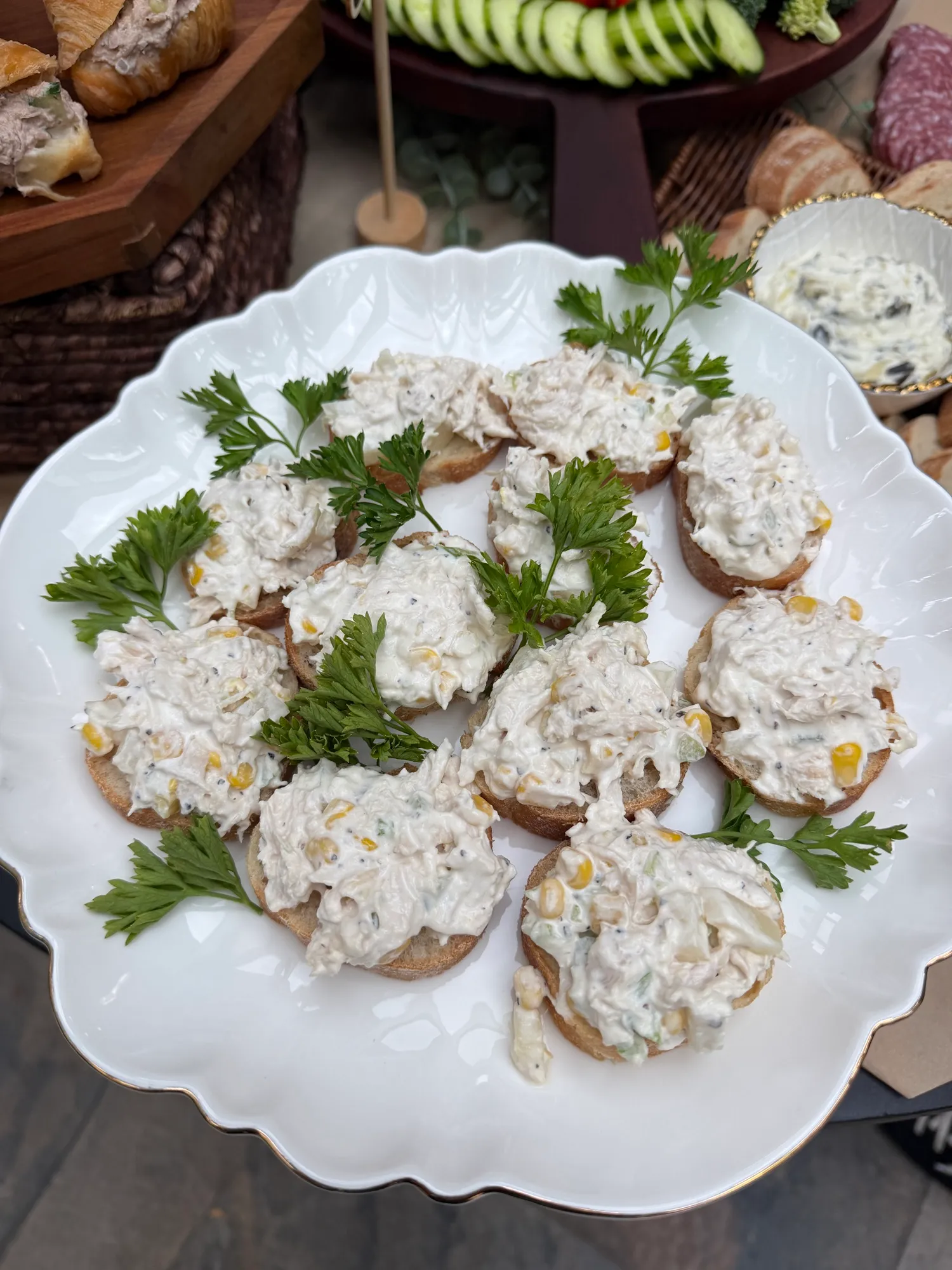 Chicken salad served on toasted rounds and garnished with parsley.