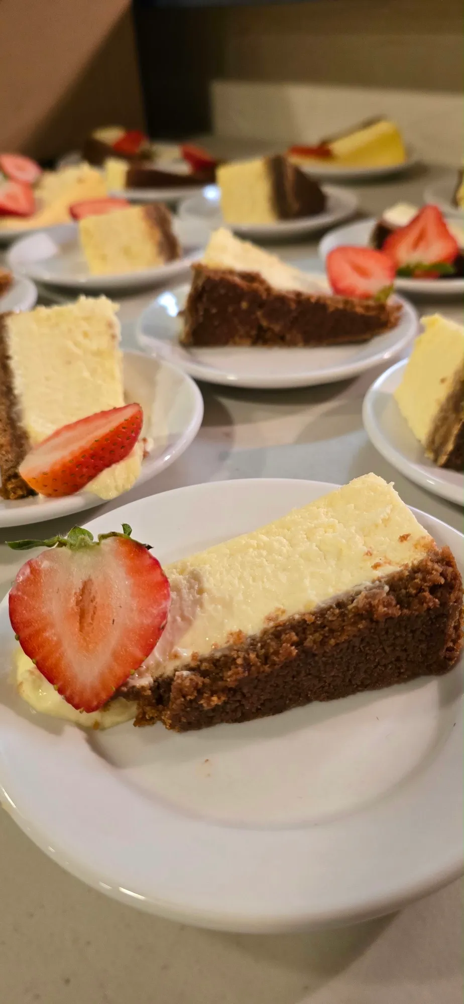 A slice of cheesecake served with a fresh strawberry.